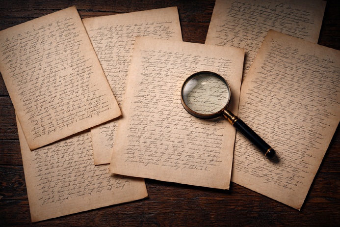 Handwritten pages spread on a desk representing the process of interpreting results within Automatic Writing Traditions