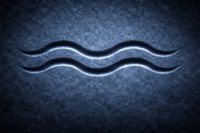 Two parallel wavy lines carved in stone representing the Aquarius symbolism glyph