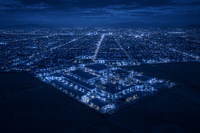 Aerial view of a mid-sized Midwest city edge where industrial land meets urban neighborhoods, illustrating Midwest industrial growth potential